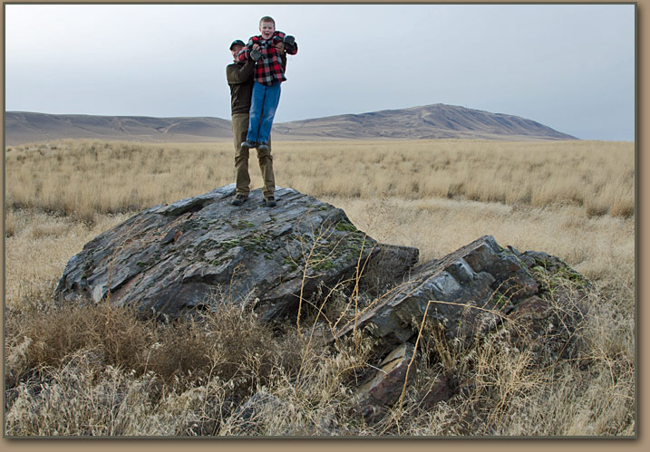 Tom and Luke Foster on top of arillite erratic on lower slope of Rattlesnake Mountain.